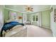 Bright bedroom featuring neutral carpet, fresh sage green walls, and a ceiling fan for year-round comfort at 471 Henderson Lake Dr, Canton, GA 30115