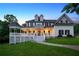 Elegant two-story home featuring a covered porch with ample seating space and manicured landscaping at 471 Henderson Lake Dr, Canton, GA 30115