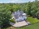 Stunning exterior view of a white home with a black shingle roof, a four car garage, and a fenced yard at 471 Henderson Lake Dr, Canton, GA 30115