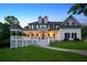 Beautiful two-story home featuring a covered porch, dormer windows, and manicured lawn at dusk at 471 Henderson Lake Dr, Canton, GA 30115