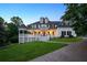 Charming home featuring a spacious front porch, manicured lawn, and traditional architectural details at 471 Henderson Lake Dr, Canton, GA 30115