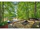 Lakeside fire pit with wooden benches, perfect for outdoor entertaining and enjoying nature at 471 Henderson Lake Dr, Canton, GA 30115