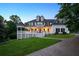 Stunning two-story home features a large front porch, dormer windows, and a well-manicured lawn at 471 Henderson Lake Dr, Canton, GA 30115