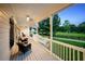 Inviting front porch with rocking chairs, white railings, and a view of the well-maintained yard at 471 Henderson Lake Dr, Canton, GA 30115