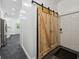 Hallway with wood sliding barn door leading to kitchen and exterior access door at 471 Henderson Lake Dr, Canton, GA 30115