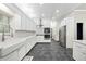 Spacious kitchen with white cabinets, stainless steel appliances, and stone tile flooring at 471 Henderson Lake Dr, Canton, GA 30115