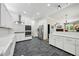 Well-lit kitchen featuring stainless steel appliances, ample counter space and stone tile flooring at 471 Henderson Lake Dr, Canton, GA 30115