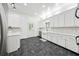 Bright kitchen with white cabinetry, stainless steel appliances, and gray tile flooring at 471 Henderson Lake Dr, Canton, GA 30115