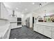 Open kitchen with white cabinets, stainless steel appliances, tile backsplash, and view to the dining area at 471 Henderson Lake Dr, Canton, GA 30115
