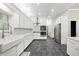 Bright kitchen with white cabinetry, stainless steel appliances, and gray tile flooring at 471 Henderson Lake Dr, Canton, GA 30115