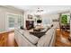 Cozy living room featuring a fireplace, hardwood floors, a comfortable sectional couch, and great natural light at 471 Henderson Lake Dr, Canton, GA 30115
