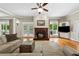 Inviting living room with hardwood floors, fireplace, TV, and access to outdoor balconies, providing a warm and airy space at 471 Henderson Lake Dr, Canton, GA 30115