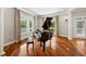 Living room featuring a grand piano, hardwood floors, and natural light, perfect for entertaining guests at 471 Henderson Lake Dr, Canton, GA 30115