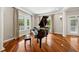 Elegant living area featuring a grand piano, hardwood floors, and natural light from large windows at 471 Henderson Lake Dr, Canton, GA 30115