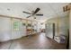 Bright living room with tile flooring, vintage ceiling fan, and a doorway to another room at 471 Henderson Lake Dr, Canton, GA 30115