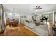 Open-concept living room featuring hardwood floors, a grand piano, and a comfortable seating area at 471 Henderson Lake Dr, Canton, GA 30115