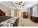 Main bedroom with tray ceiling, carpet, barn door, and natural light at 471 Henderson Lake Dr, Canton, GA 30115