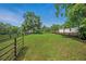 Lush green paddock enclosed by a wooden fence, offering ample space for grazing at 471 Henderson Lake Dr, Canton, GA 30115