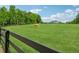 Picturesque pasture featuring a horse grazing, with a distant view of the home at 471 Henderson Lake Dr, Canton, GA 30115