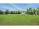 Picturesque view of a large green pasture with a horse grazing peacefully near a white home at 471 Henderson Lake Dr, Canton, GA 30115