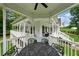 Spacious outdoor patio featuring a table, connecting to the house's inviting porch and surrounding landscape at 471 Henderson Lake Dr, Canton, GA 30115