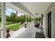 Inviting covered porch with white railings, ceiling fans, and outdoor seating area overlooking the landscaped front yard at 471 Henderson Lake Dr, Canton, GA 30115