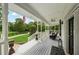 Inviting covered porch with outdoor seating and views of the expansive lawn and garden at 471 Henderson Lake Dr, Canton, GA 30115