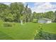Expansive backyard featuring a lush green lawn and a shed, creating a serene outdoor space at 4911 Old Douglasville Rd, Lithia Springs, GA 30122