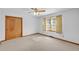 Simple bedroom with carpet flooring, a window, and closet, offering a cozy and functional space at 4911 Old Douglasville Rd, Lithia Springs, GA 30122