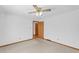Spacious bedroom with a neutral carpet, ceiling fan and door leading to other rooms at 4911 Old Douglasville Rd, Lithia Springs, GA 30122