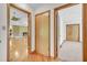 Hallway with hardwood floors and doors leading to various rooms, including the living room and bedroom at 4911 Old Douglasville Rd, Lithia Springs, GA 30122
