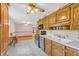 Eat-in kitchen with wooden cabinets, tile floors, and stainless steel appliances at 4911 Old Douglasville Rd, Lithia Springs, GA 30122