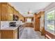 Bright eat-in kitchen with wooden cabinets, tile floors, and stainless steel appliances at 4911 Old Douglasville Rd, Lithia Springs, GA 30122