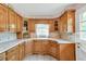 Charming kitchen with wooden cabinets and a large window over the sink at 4911 Old Douglasville Rd, Lithia Springs, GA 30122