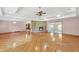 Expansive living room boasts hardwood floors, tray ceilings, and a cozy brick fireplace at 4911 Old Douglasville Rd, Lithia Springs, GA 30122
