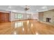 Spacious living area featuring gleaming hardwood floors and a classic brick fireplace at 4911 Old Douglasville Rd, Lithia Springs, GA 30122