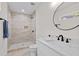 Modern bathroom with a walk-in shower, featuring tan tiling and black hardware at 5 Windsor Ter, Avondale Estates, GA 30002