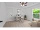 Bright bedroom featuring a ceiling fan, office desk, and a large window with natural light at 5 Windsor Ter, Avondale Estates, GA 30002