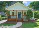 Charming home featuring a welcoming front porch with wooden posts and a well-manicured lawn at 5 Windsor Ter, Avondale Estates, GA 30002