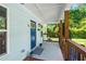Welcoming front porch featuring wooden railings, a beadboard ceiling, and a charming blue door at 5 Windsor Ter, Avondale Estates, GA 30002