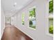 Hallway with hardwood floors and white walls that connects the kitchen at 5 Windsor Ter, Avondale Estates, GA 30002
