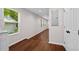Hallway featuring hardwood floors, white walls, and multiple windows with natural light at 5 Windsor Ter, Avondale Estates, GA 30002