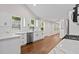 Bright kitchen featuring white cabinets, marble countertops, stainless steel appliances, and hardwood floors at 5 Windsor Ter, Avondale Estates, GA 30002