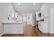 Open kitchen featuring white cabinets, stainless steel appliances, hardwood floors, and marble countertops at 5 Windsor Ter, Avondale Estates, GA 30002