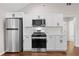 Modern kitchen featuring stainless steel appliances, white cabinetry, and hardwood floors at 5 Windsor Ter, Avondale Estates, GA 30002