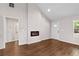 Bright, open-concept living room featuring laminate wood floors and a modern electric fireplace at 5 Windsor Ter, Avondale Estates, GA 30002