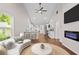 Bright living room boasts an open floor plan, modern fireplace and ceiling fan at 5 Windsor Ter, Avondale Estates, GA 30002