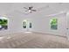 Bright main bedroom with large windows, neutral carpet, and a modern ceiling fan at 5 Windsor Ter, Avondale Estates, GA 30002