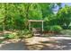 Secluded outdoor bench with overhead cover for peaceful relaxing in lush, mature backyard at 5 Windsor Ter, Avondale Estates, GA 30002