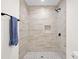 Modern shower with neutral tile, black hardware, and a shower niche for storage at 5 Windsor Ter, Avondale Estates, GA 30002
